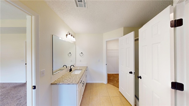 1142 S Jasmine Ln, Fayetteville, AR 72704 - bathroom featuring vanity, a textured ceiling, and tile patterned floors