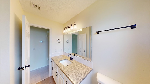 1142 S Jasmine Ln, Fayetteville, AR 72704 - half bathroom with vanity, tile patterned floors, and a textured ceiling