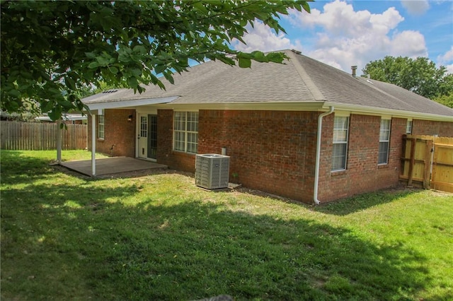 1142 S Jasmine Ln, Fayetteville, AR 72704 - back of property featuring a patio area, a shingled roof, a fenced backyard, and brick siding