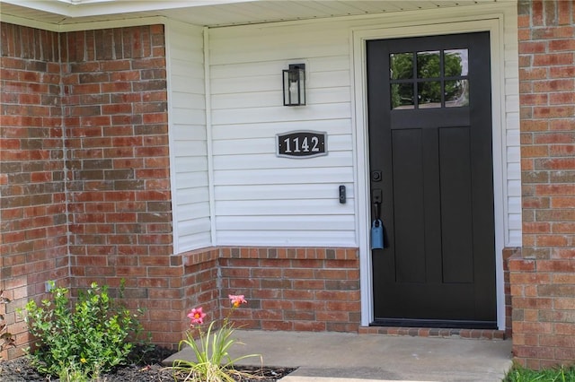 1142 S Jasmine Ln, Fayetteville, AR 72704 - view of exterior entry featuring brick siding