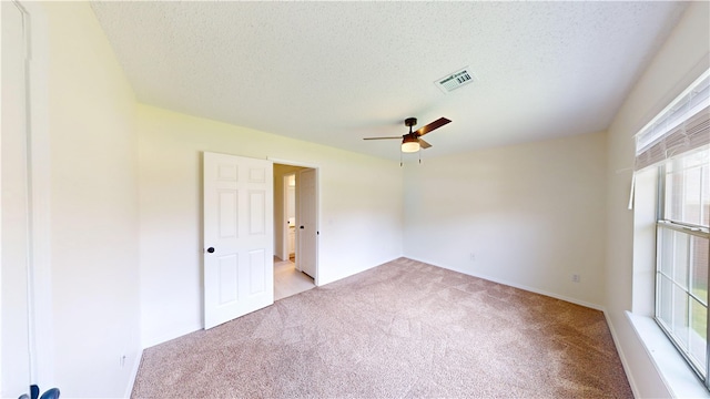 1142 S Jasmine Ln, Fayetteville, AR 72704 - spare room with light colored carpet, ceiling fan, and a textured ceiling