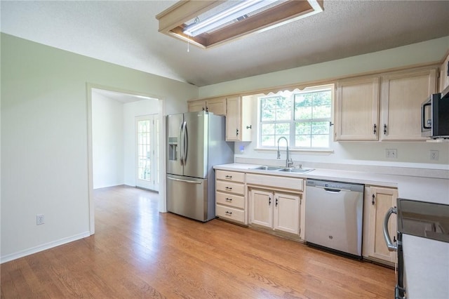 2472 W Jane Circle Dr, Fayetteville, AR 72704 - kitchen featuring stainless steel appliances, light wood-type flooring, light countertops, and vaulted ceiling