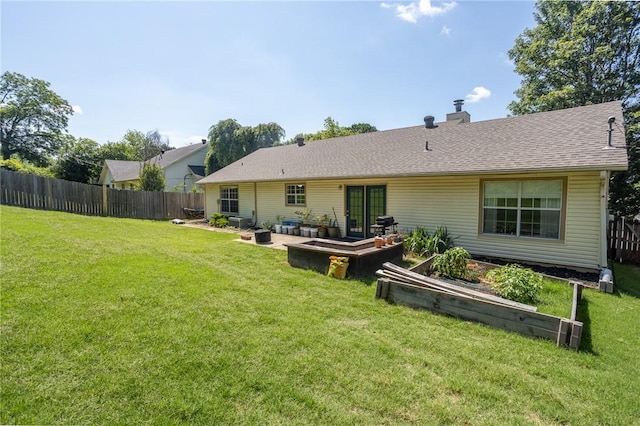 2472 W Jane Circle Dr, Fayetteville, AR 72704 - rear view of property featuring a chimney, a vegetable garden, a patio, and roof with shingles