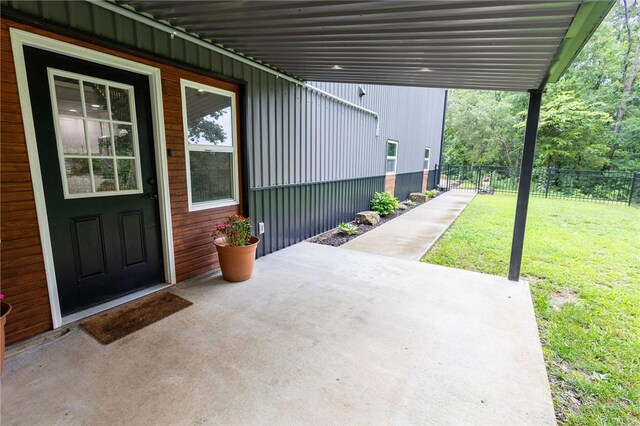 19475 Cotton Ln, Garfield, AR 72732 - view of exterior entry featuring a patio area and board and batten siding