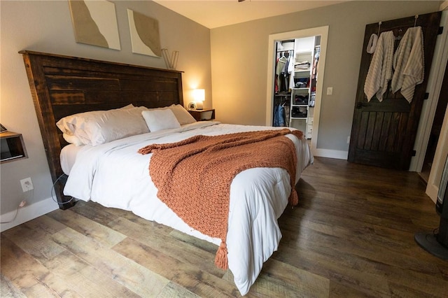 19475 Cotton Ln, Garfield, AR 72732 - bedroom featuring a walk in closet, wood finished floors, and a closet