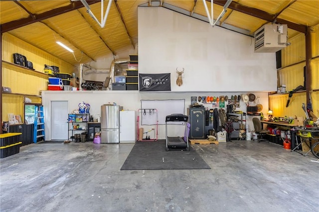 19475 Cotton Ln, Garfield, AR 72732 - garage with freestanding refrigerator, a workshop area, and a heating unit