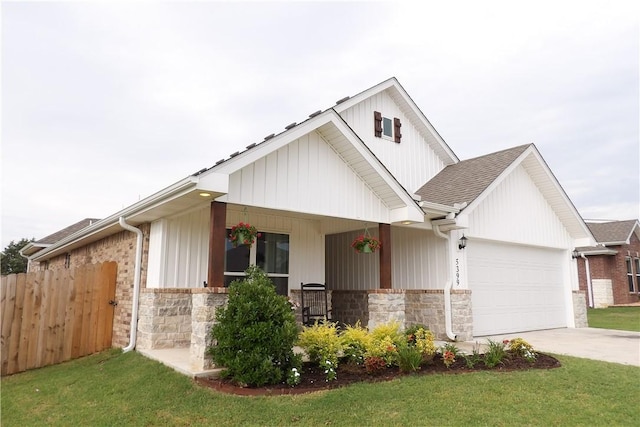 5399 Clear Springs Ave, Springdale, AR 72762 - view of front of house with covered porch, an attached garage, stone siding, and driveway
