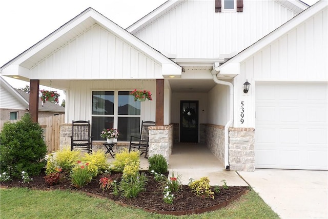 5399 Clear Springs Ave, Springdale, AR 72762 - view of front facade with a porch, stone siding, a garage, and board and batten siding