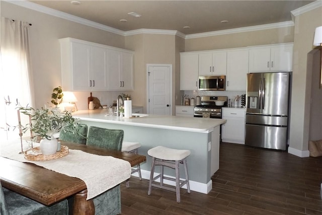 5399 Clear Springs Ave, Springdale, AR 72762 - kitchen with stainless steel appliances, dark wood-type flooring, light countertops, white cabinets, and a peninsula