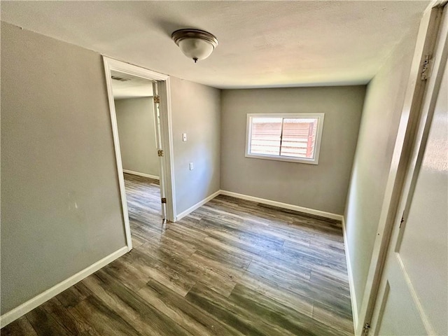 705 Commerce St, Morrilton, AR 72110 - empty room featuring baseboards and wood finished floors