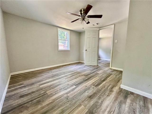 705 Commerce St, Morrilton, AR 72110 - empty room with wood finished floors and a ceiling fan