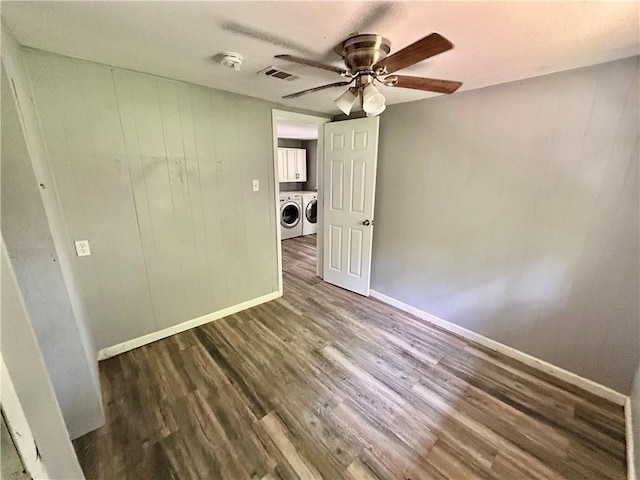 705 Commerce St, Morrilton, AR 72110 - spare room featuring washing machine and clothes dryer, a ceiling fan, wood finished floors, a smoke detector, and wood walls