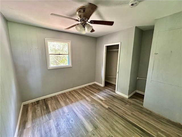 705 Commerce St, Morrilton, AR 72110 - unfurnished bedroom with wood finished floors, a closet, and ceiling fan