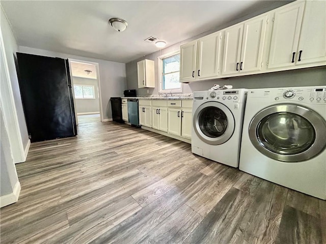 705 Commerce St, Morrilton, AR 72110 - laundry area with separate washer and dryer, light wood-type flooring, and plenty of natural light