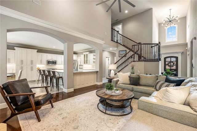 5503 S Turnberry Rd, Rogers, AR 72758 - living area featuring a towering ceiling, arched walkways, ceiling fan, dark wood-style floors, and recessed lighting