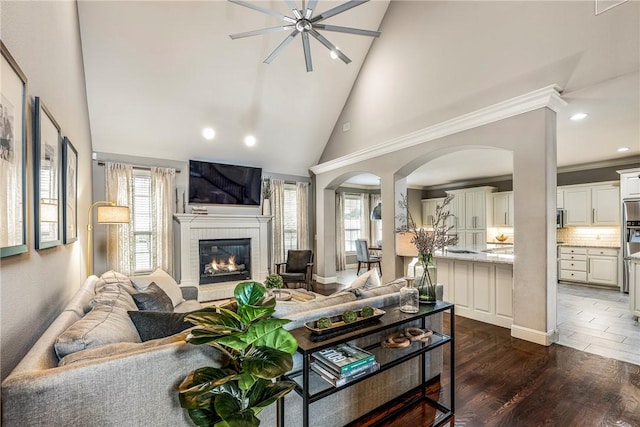 5503 S Turnberry Rd, Rogers, AR 72758 - living room with arched walkways, healthy amount of natural light, a fireplace, high vaulted ceiling, and recessed lighting