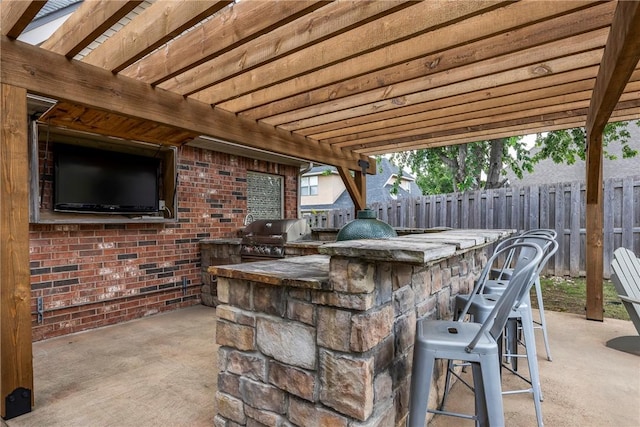 5503 S Turnberry Rd, Rogers, AR 72758 - fenced backyard with an outdoor kitchen and a patio area