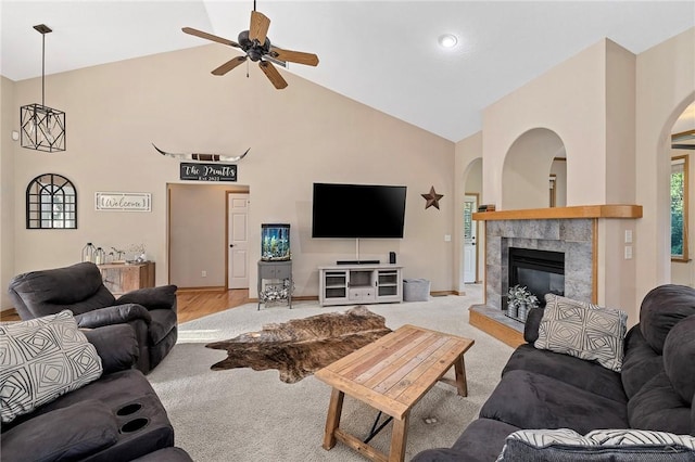 6 Leawood Pl, Bella Vista, AR 72715 - living room featuring high vaulted ceiling, arched walkways, ceiling fan, and a tiled fireplace