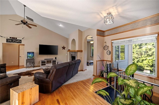 6 Leawood Pl, Bella Vista, AR 72715 - living area with ceiling fan, vaulted ceiling, light wood-type flooring, a fireplace, and arched walkways