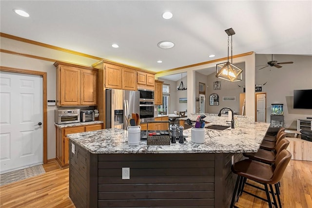 6 Leawood Pl, Bella Vista, AR 72715 - kitchen with stainless steel appliances, light wood finished floors, light stone counters, a kitchen breakfast bar, and recessed lighting