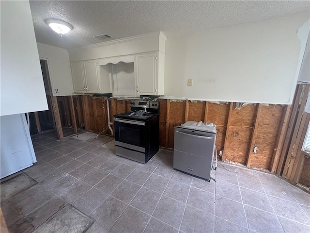 1811 Birchwood, Beebe, AR 72012 - kitchen featuring stainless steel electric stove, a textured ceiling, refrigerator, white cabinetry, and a wainscoted wall