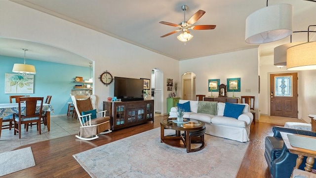 3809 N 2nd Pl, Rogers, AR 72756 - living room featuring arched walkways, wood finished floors, ceiling fan, and high vaulted ceiling