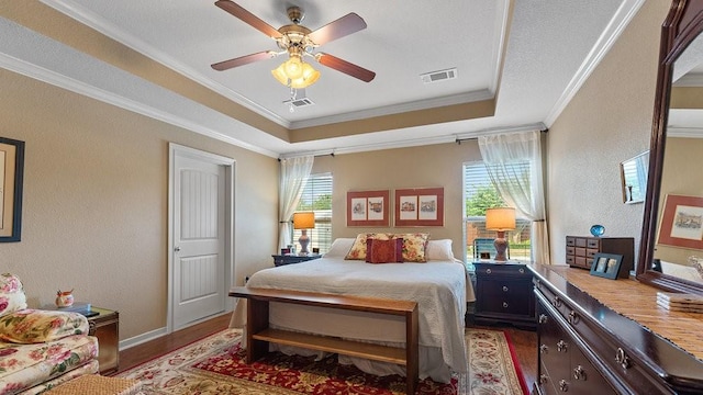 3809 N 2nd Pl, Rogers, AR 72756 - bedroom with wood finished floors, multiple windows, crown molding, a textured wall, and a tray ceiling