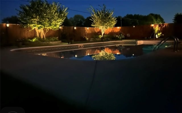 3809 N 2nd Pl, Rogers, AR 72756 - pool at night with a fenced backyard