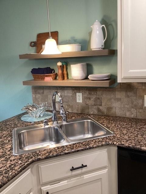 3809 N 2nd Pl, Rogers, AR 72756 - kitchen view of open shelves, dishwasher, white cabinets, decorative backsplash, and dark stone counters