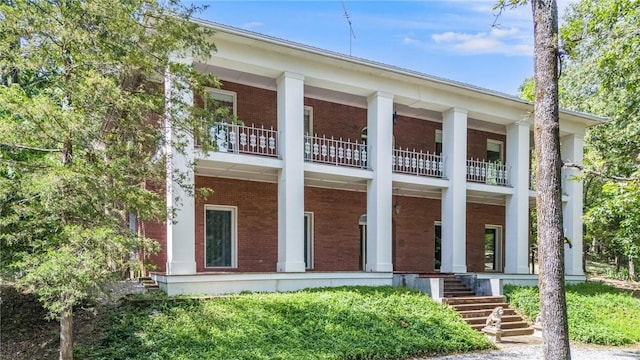 14074 Old Mill Rd, Elkins, AR 72727 - view of front of property with a balcony, brick siding, and covered porch