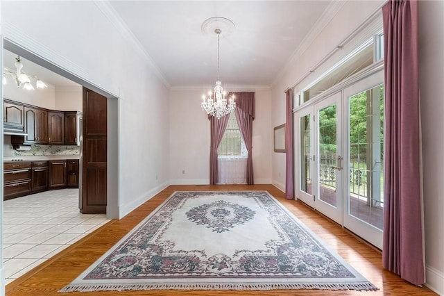 14074 Old Mill Rd, Elkins, AR 72727 - unfurnished dining area featuring a chandelier, french doors, plenty of natural light, light wood-style flooring, and ornamental molding