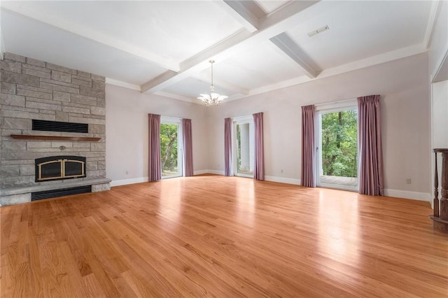 14074 Old Mill Rd, Elkins, AR 72727 - unfurnished living room featuring a chandelier, healthy amount of natural light, a fireplace, wood finished floors, and beamed ceiling