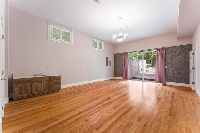 14074 Old Mill Rd, Elkins, AR 72727 - empty room with a chandelier and light wood-type flooring