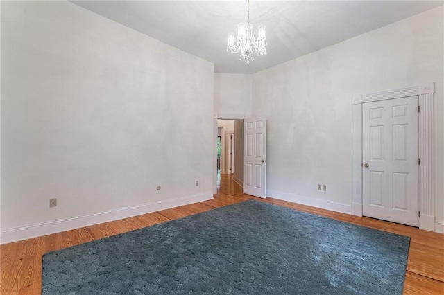 14074 Old Mill Rd, Elkins, AR 72727 - empty room featuring a chandelier and wood finished floors