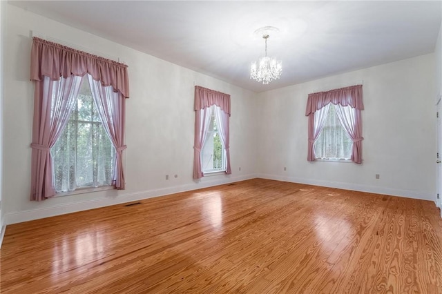 14074 Old Mill Rd, Elkins, AR 72727 - unfurnished room with a chandelier, healthy amount of natural light, and light wood finished floors