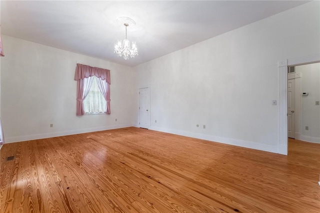 14074 Old Mill Rd, Elkins, AR 72727 - spare room with a chandelier and light wood-type flooring