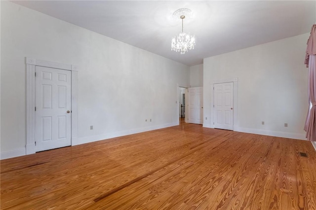 14074 Old Mill Rd, Elkins, AR 72727 - empty room featuring a chandelier and light wood finished floors