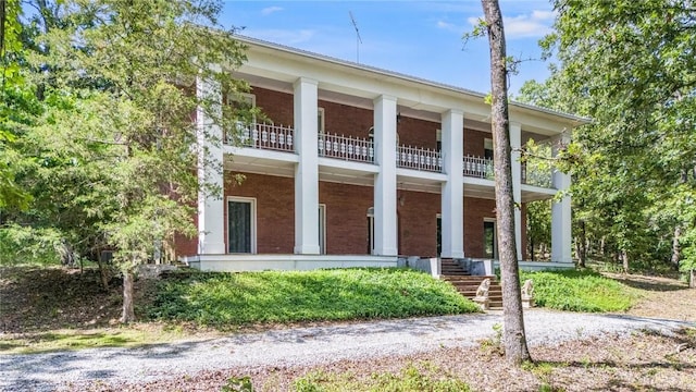 14074 Old Mill Rd, Elkins, AR 72727 - view of front facade with a balcony, brick siding, and covered porch