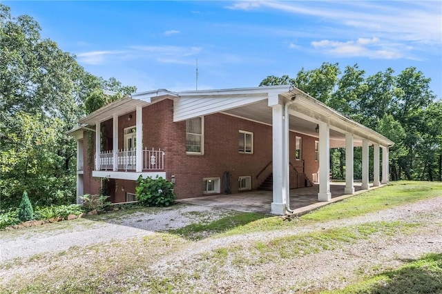 14074 Old Mill Rd, Elkins, AR 72727 - view of home's exterior with brick siding and an attached carport
