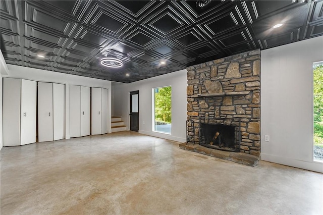 25 Grisham Cir, Bella Vista, AR 72715 - unfurnished living room with an ornate ceiling, finished concrete flooring, healthy amount of natural light, and stairway