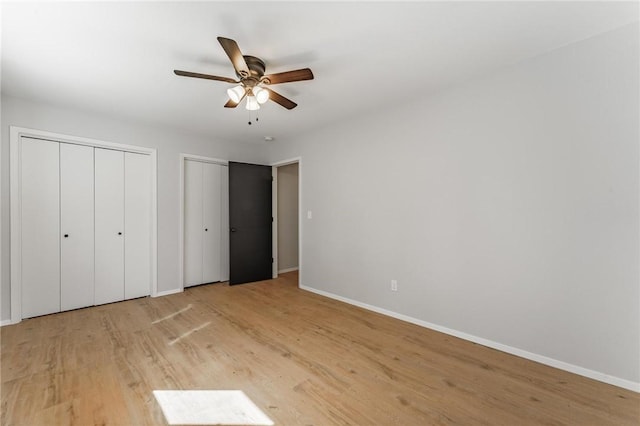 25 Grisham Cir, Bella Vista, AR 72715 - unfurnished bedroom with multiple closets, light wood-style floors, and a ceiling fan