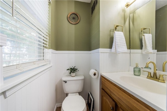 805 S Oak Hill St, Siloam Springs, AR 72761 - half bathroom with a wainscoted wall, vanity, and a decorative wall