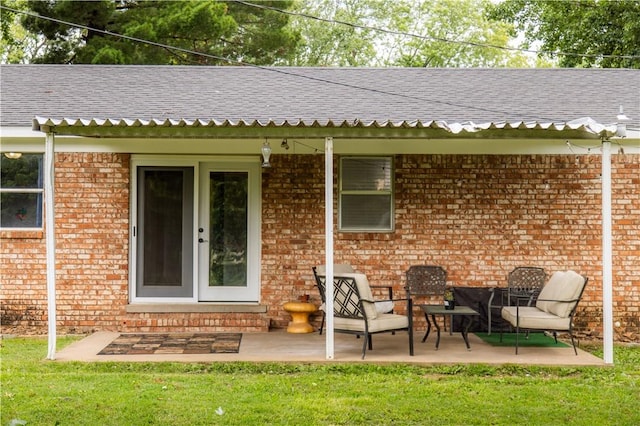 805 S Oak Hill St, Siloam Springs, AR 72761 - rear view of house featuring brick siding, roof with shingles, a patio area, and a yard