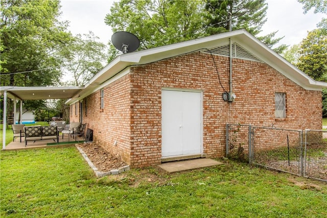 805 S Oak Hill St, Siloam Springs, AR 72761 - view of property exterior featuring outdoor lounge area, brick siding, a gate, and a patio area