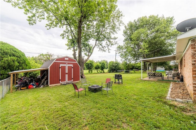 805 S Oak Hill St, Siloam Springs, AR 72761 - view of yard with a fire pit, a storage unit, and a patio area
