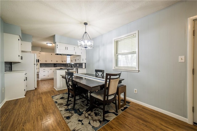 805 S Oak Hill St, Siloam Springs, AR 72761 - dining area with a chandelier and dark wood finished floors