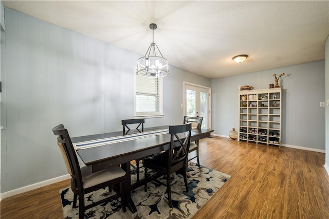 805 S Oak Hill St, Siloam Springs, AR 72761 - dining space featuring wood finished floors and a chandelier