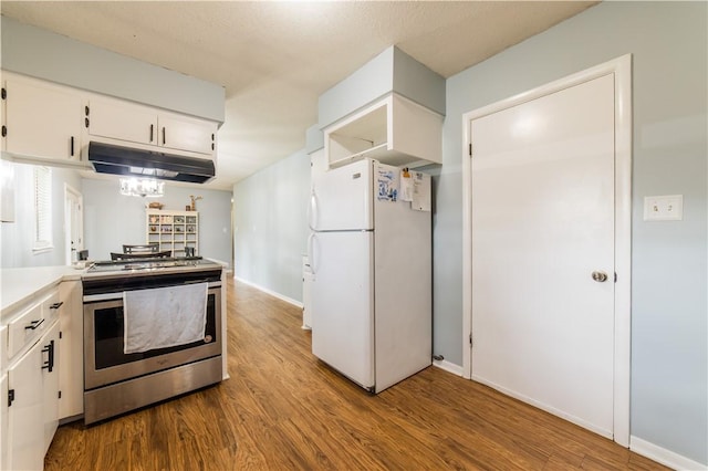 805 S Oak Hill St, Siloam Springs, AR 72761 - kitchen featuring freestanding refrigerator, stainless steel range with electric cooktop, under cabinet range hood, and wood finished floors