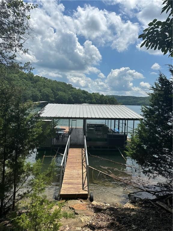 393 Timberlake Ln, Eureka Springs, AR 72631 - dock featuring a water view, boat lift, and a wooded view