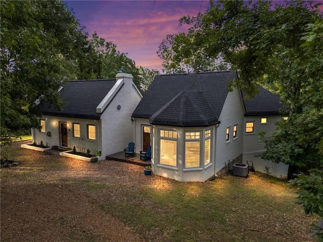 393 Timberlake Ln, Eureka Springs, AR 72631 - back of property at dusk with a chimney and a shingled roof